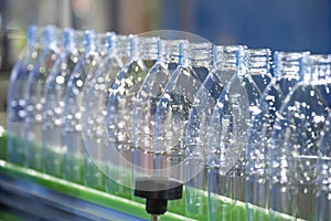 The empty drinking water bottles  on the conveyor belt for filling process