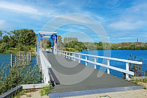 Empty dutch bicycle and pedestrian bridge over lake in summer - Thorn (Heggerplas), Netherlands