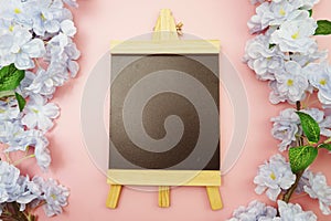 Empty Easel Space copy for text with Blooming flowers on pink background