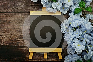 Empty Easel Space copy for text with Blooming flowers on wooden background