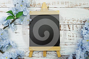 Empty Easel Space copy for text with Blooming Flowers on wooden background