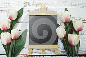 Empty Easel Space copy for text with Tulip Flowers on wooden background