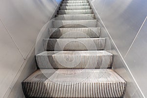 Empty electric escalators going up, stainless steel finishings, closeup view