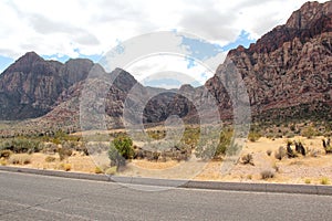 Empty and endless road surrounded by mountains in Las Vegas.