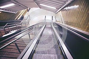 Empty escalator and stair in pedestrian subway railway station.