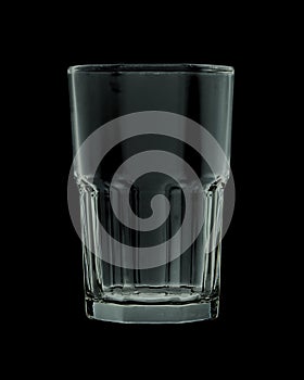 Empty faceted glass isolated on black background. Closeup