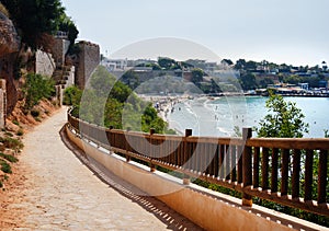 Empty fenced walkway leading to the Cabo Roig beach photo