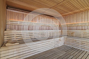 Empty Finnish sauna room. Modern interior of wooden spa cabin with dry steam