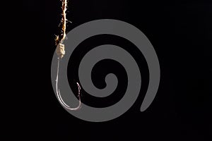 Empty fishing hook on a dark background. Metal fishing hook.