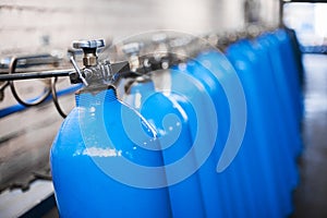 Oxygen cylinder with compressed gas. Blue Oxygen tanks for industry. Liquefied oxygen production. Factory photo