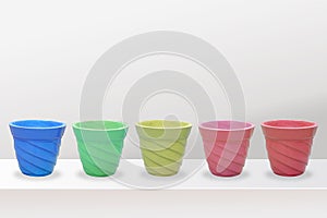 Empty flower pots of different colour and different prospective, isolated on white background, copy space.