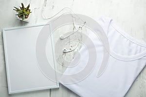 An empty folded T-shirt with a frame on a light background, for a design, a layout