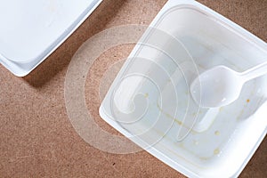 Empty food container on wood background.Top view