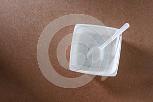 Empty food container on wood background.Top view