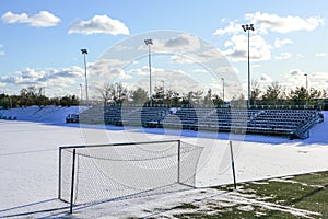 Empty football field in winter, covered with snow