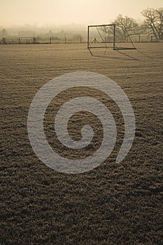 Empty football pitch and frosty winter morning