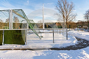 Empty Football (Soccer) Field in the Winter Partly Covered in Snow - Sunny Winter Day