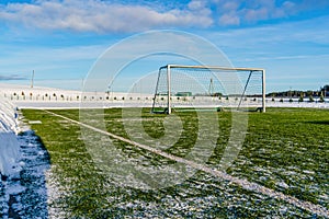 Empty Football & x28;Soccer& x29; Field in the Winter Partly Covered in Snow - Sunny Winter Day