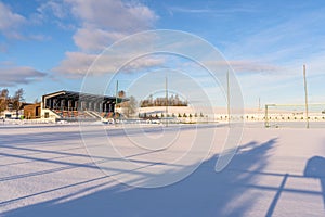 Empty Football (Soccer) Field in the Winter Partly Covered in Snow - Sunny Winter Day