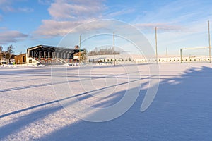 Empty Football (Soccer) Field in the Winter Partly Covered in Snow - Sunny Winter Day