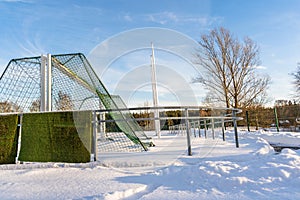 Empty Football (Soccer) Field in the Winter Partly Covered in Snow - Sunny Winter Day