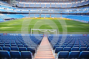 Empty football stadium with seats, rolled gates and lawn