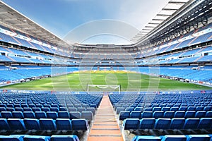 Empty football stadium with seats, rolled gates and lawn