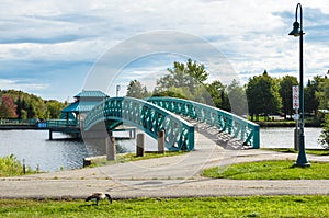 Empty footbridge in a park and cloudy sky