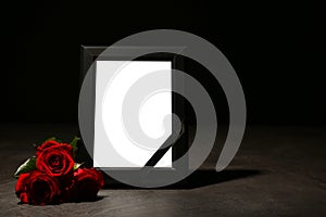 Empty frame with black ribbon and roses