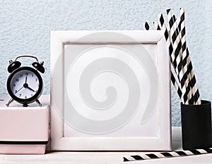 Empty frame, clock and paper straws