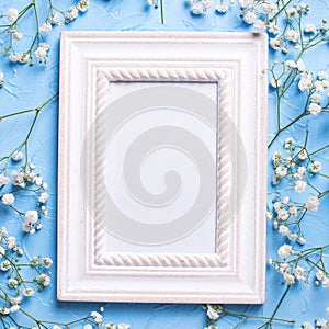 Empty frame and fresh white gypsofila flowers photo