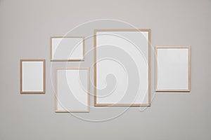 Empty frames on grey wall. Mockup for design