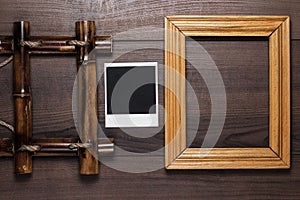 Empty frames and old photo on wooden table