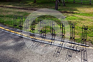 Empty free bicycle parking on an asphalt road.