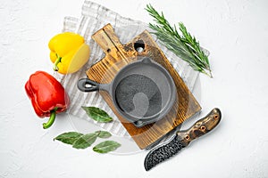Empty frying cast iron pan background, kitchenware cooking concept, on white stone  surface, top view flat lay, with copy space