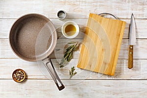 Empty frying pan with cutting board