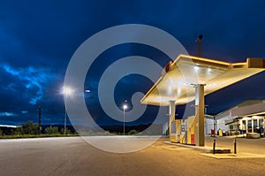 An empty fuel station at night in the summer of Bronnoysund, Norway