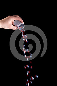 Empty a full container of capsules