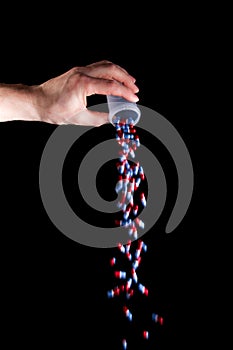 Empty a full container of capsules