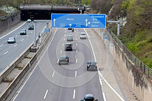 Empty German Autobahn in Dusseldorf with blue street signs and white arrows without traffic jam shows multiple lane highway ready