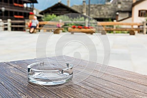 Empty glass ashtray on a wooden table