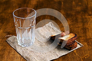 Empty glass with black rye bread and hard chucks