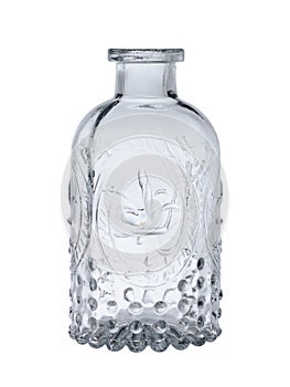 Empty glass bottle for alcohol with a beautiful pattern, for a holiday. Isolated on a white background, close-up