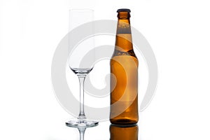 Empty glass and bottle with beer