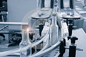 Empty glass bottles on the conveyor. Factory for bottling alcoholic beverages. Production and bottling of alcoholic beverages conc