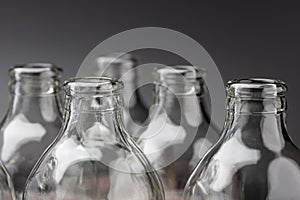Empty glass bottles in a row on black background