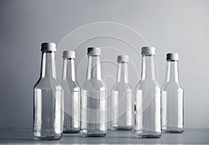 Empty glass cocoktail bottle with white cap mockup set