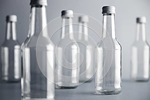 Empty glass cocoktail bottle with white cap mockup set