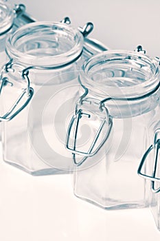 Empty glass food storage jars with a clip top seal isolated.