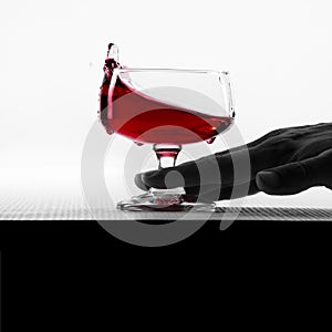 Empty glass, glass with red wine bottle, shake with hand